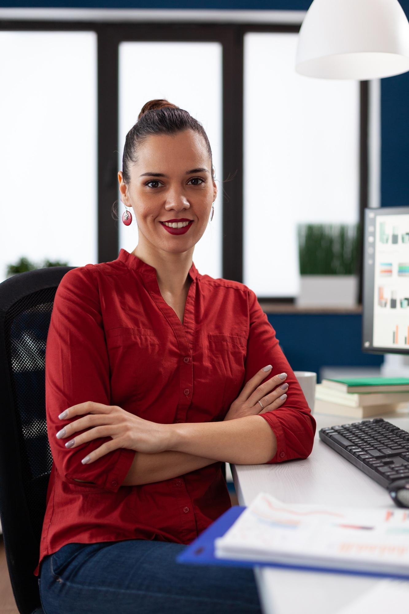 Portrait of entrepreneur sitting at desk in startup office