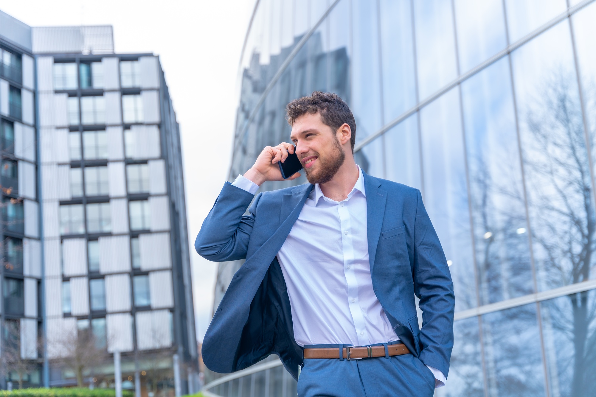 Professional corporate man businessman outside the office in a glass building
